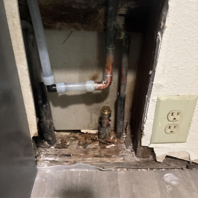 Copper and PVC pipe slab leak repair access in wall cavity