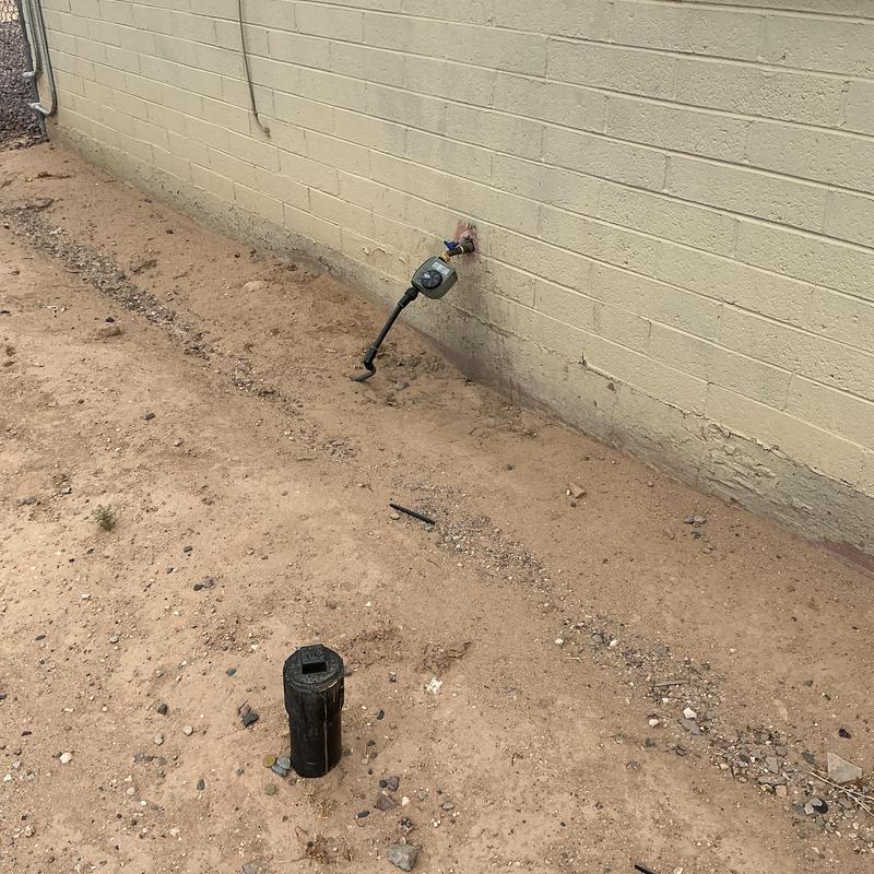 Outdoor water meter and valve connection by wall
