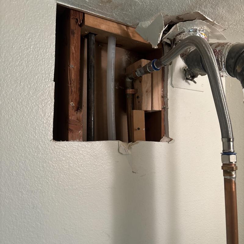 Slab leak pipe access behind drywall in residential wall