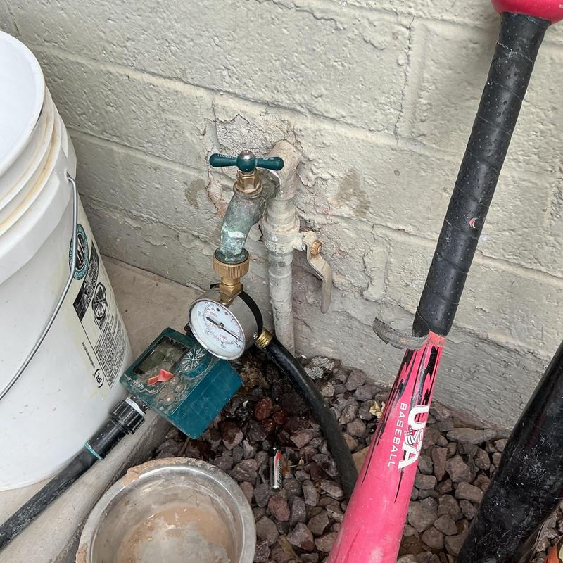 Water supply valve with pressure gauge and hose attachment