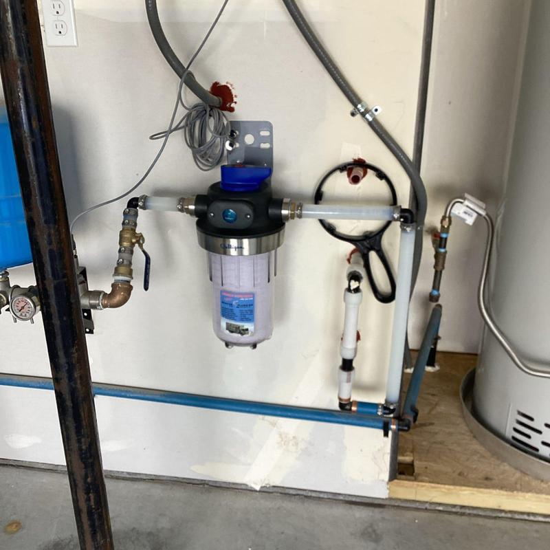 Whole house water filter installation in basement wall