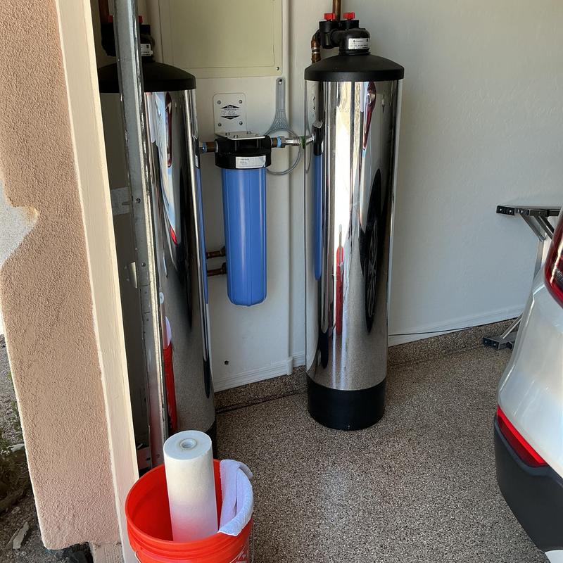 Water filtration system with blue filter replacement in garage