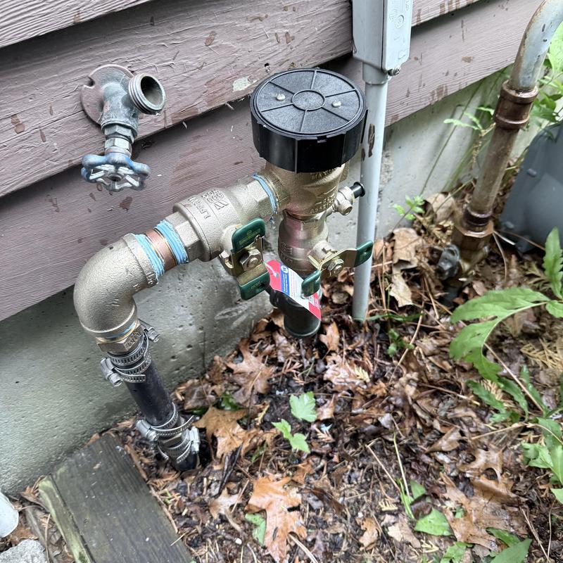 Backflow preventer valve with shutoff handles outside house Backflow preventer valve with shutoff handles outside house