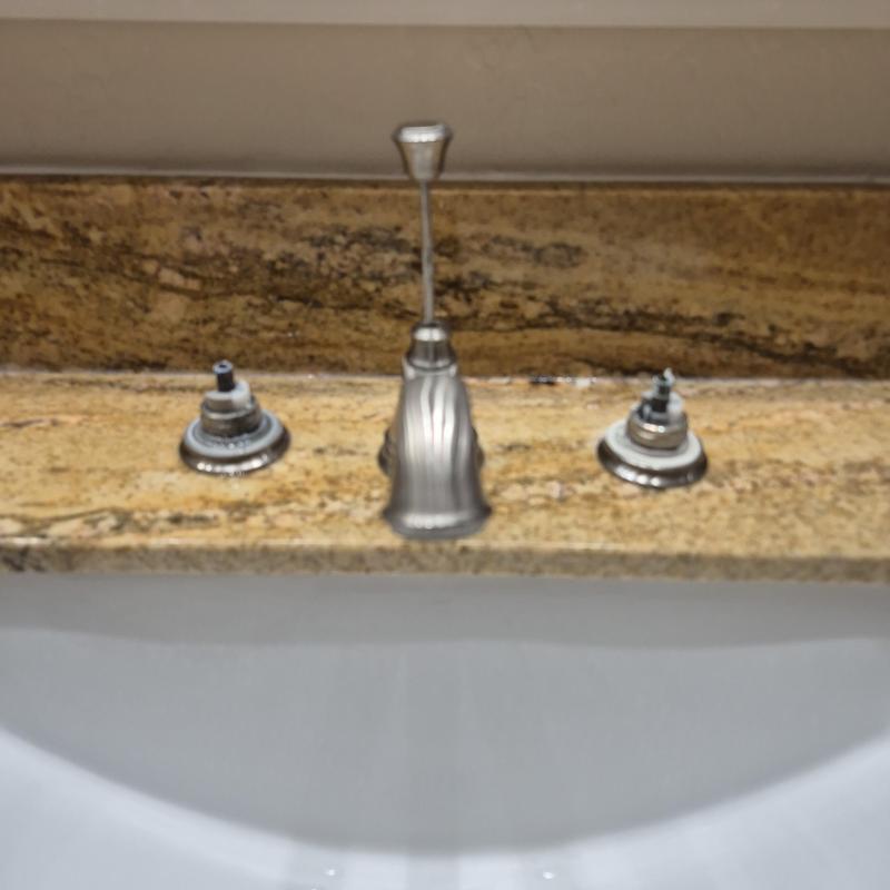 Delta 14-turn lavatory faucet double handle on granite countertop