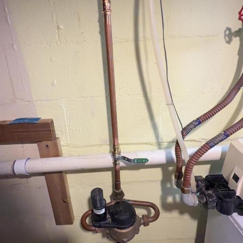 Water main shut-off valve and piping in basement wall