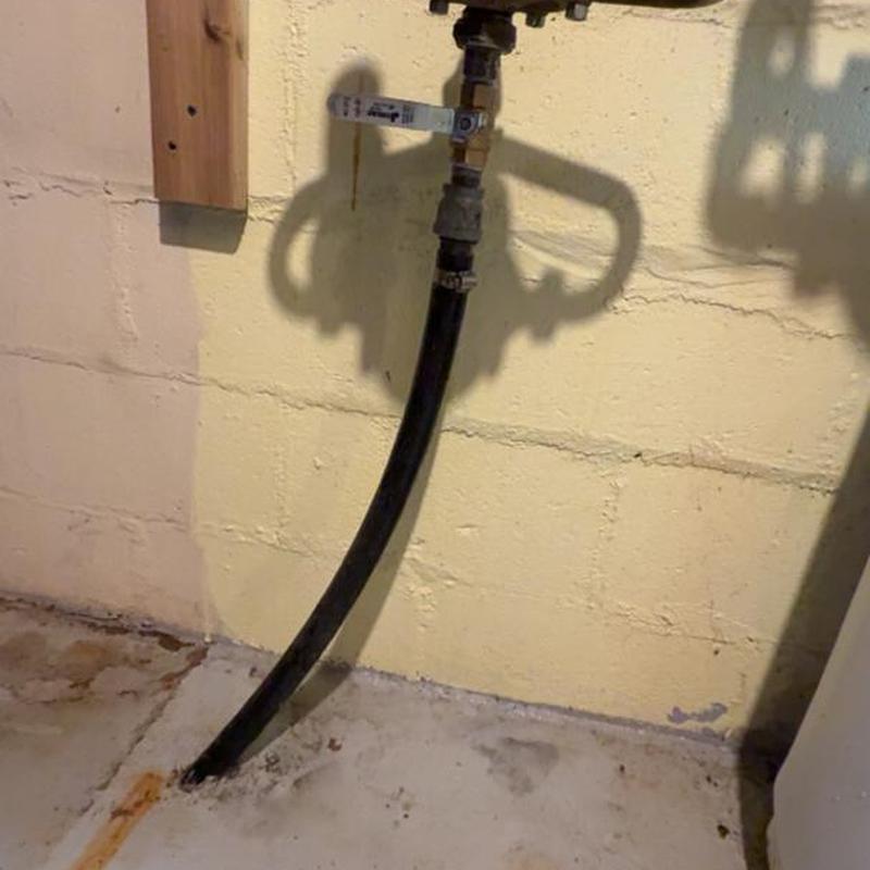 Water main valve and pipe in basement corner