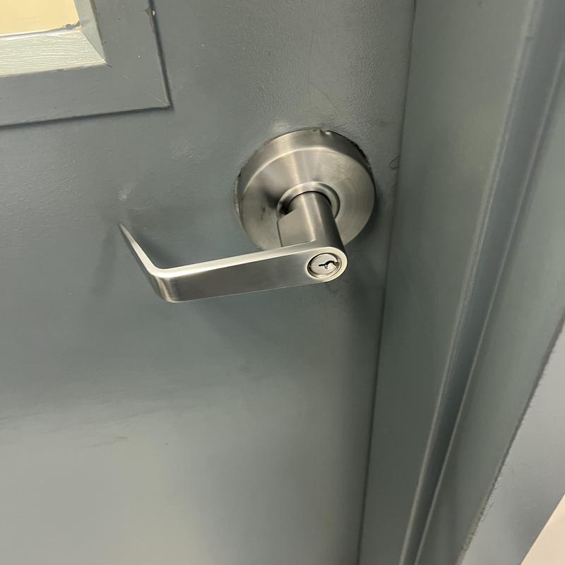Door lever lock with keyhole on gray door