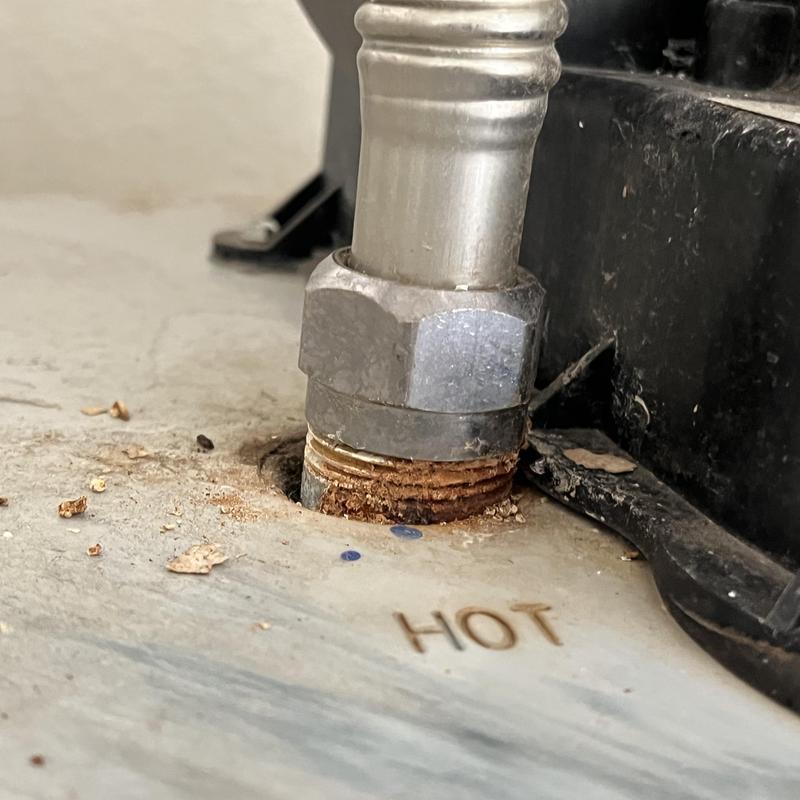 Water heater hot water pipe connection with rust buildup