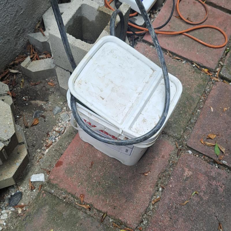 Tankless water heater descaling pump and bucket setup