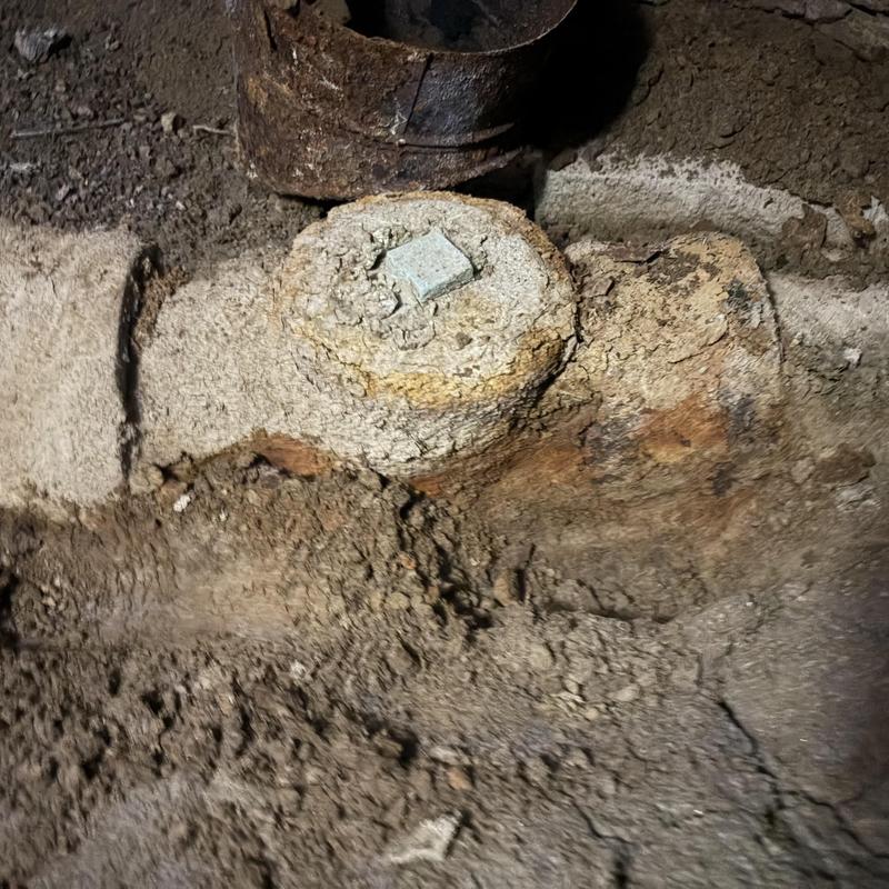 Corroded underground water main valve in dirt trench Corroded underground water main valve in dirt trench