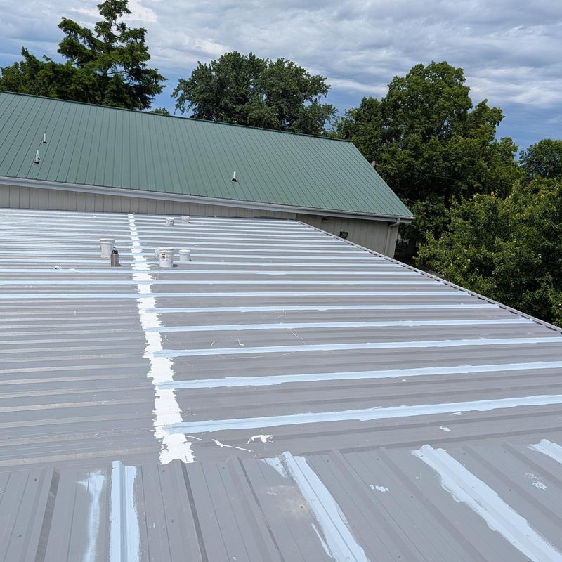 Commercial metal roof with elastomeric coating application