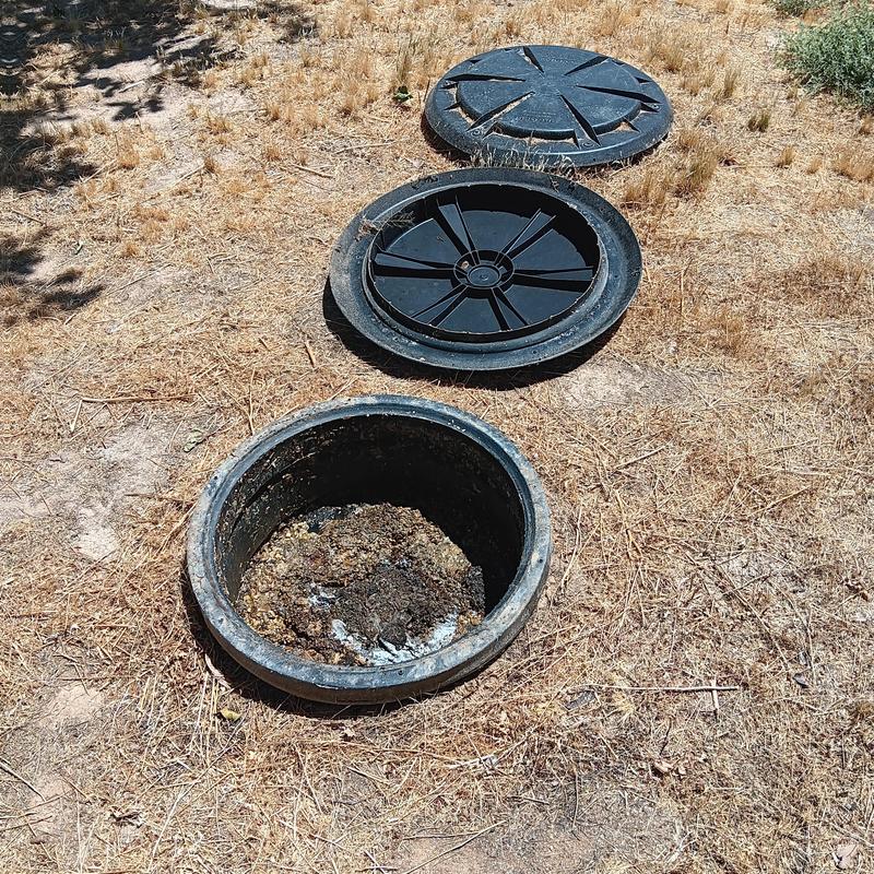 Septic tank lids removed on dry grassbed