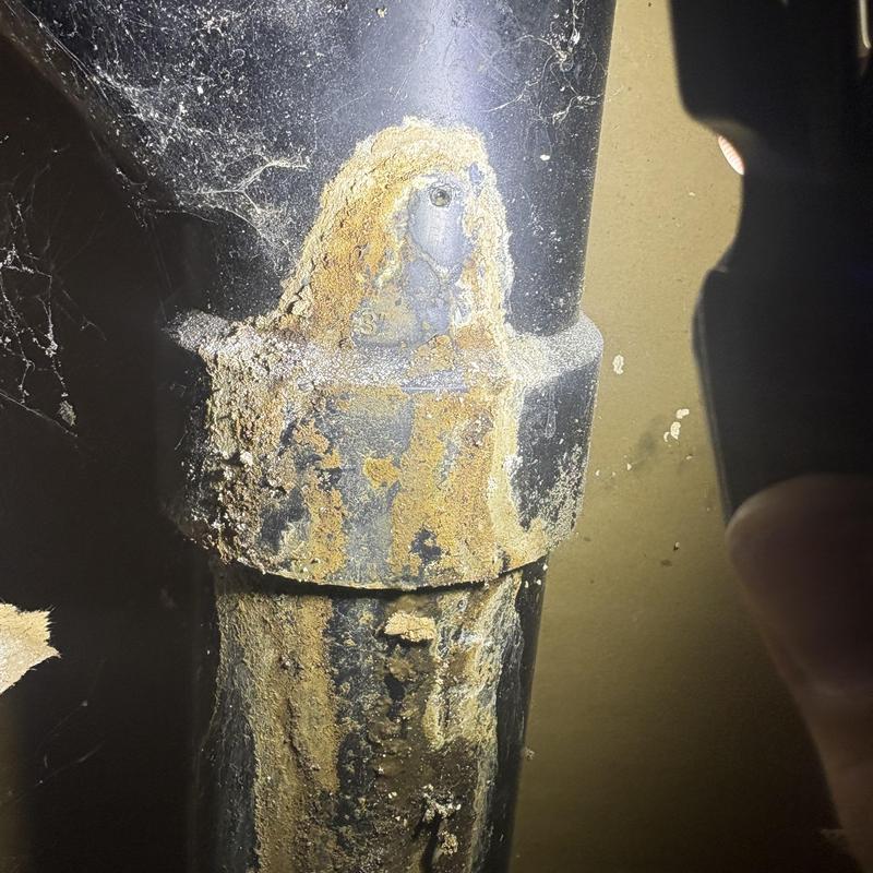 DWV ABS pipe joint with corrosion and leak residue