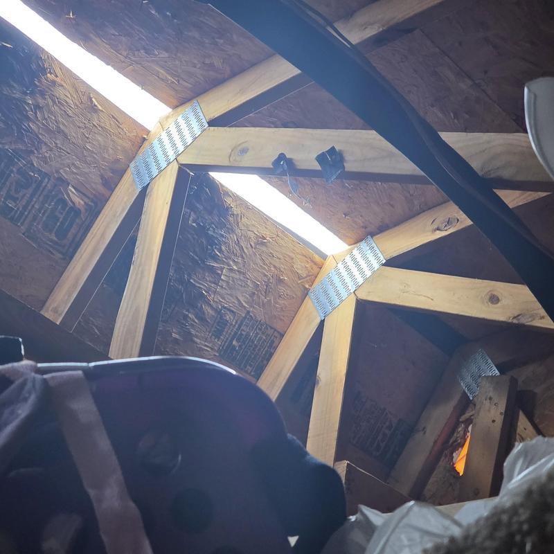 Metal ridge vent blown off showing attic dry rot damage