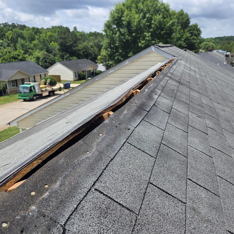 Metal ridge vent removed showing dry rot wood on roof ridge