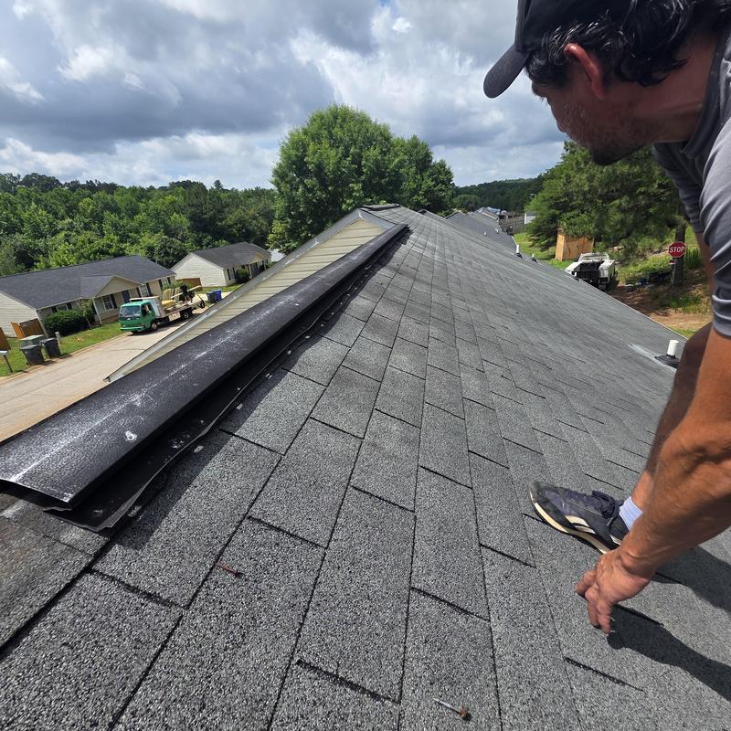 Metal ridge vent lifted on asphalt shingle roof