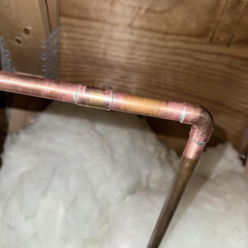 Copper pipe with soldered joints in attic insulation Copper pipe with soldered joints in attic insulation