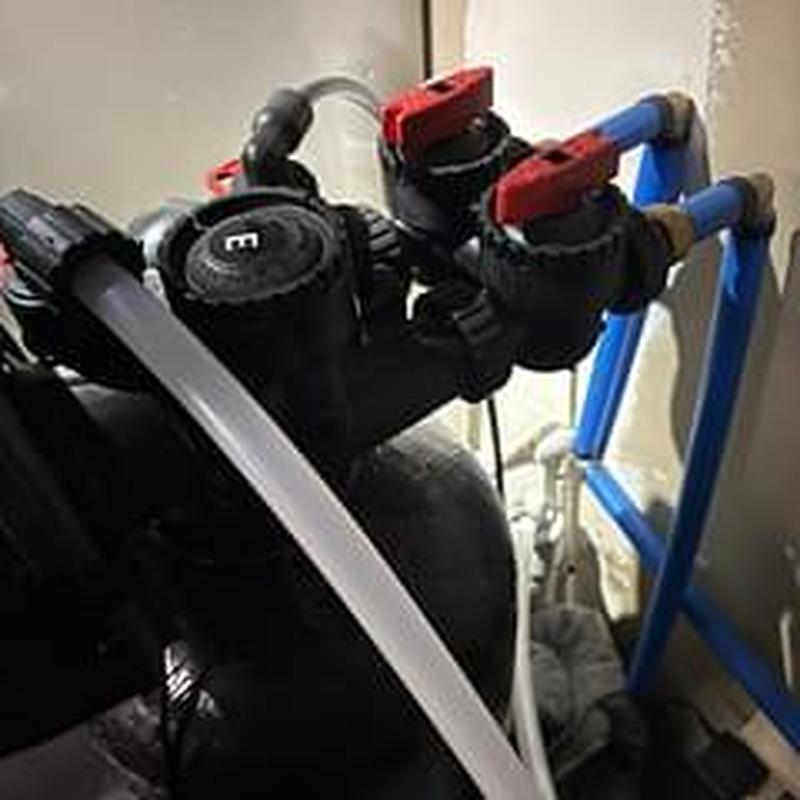 Water softener discharge pipe replacement with valves