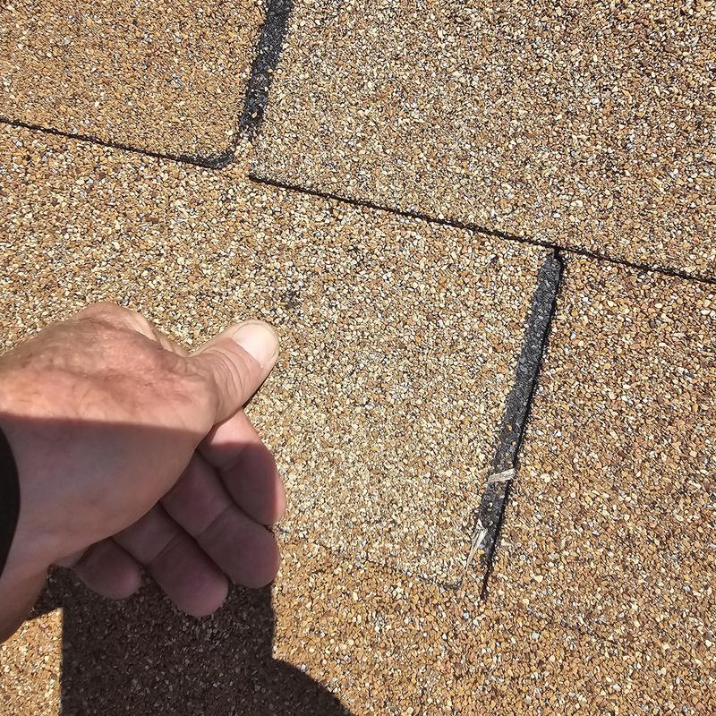 Asphalt shingle roof with hail damage inspection