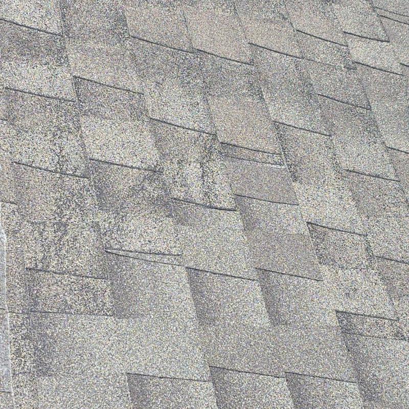 Roof shingles with visible hail damage granules