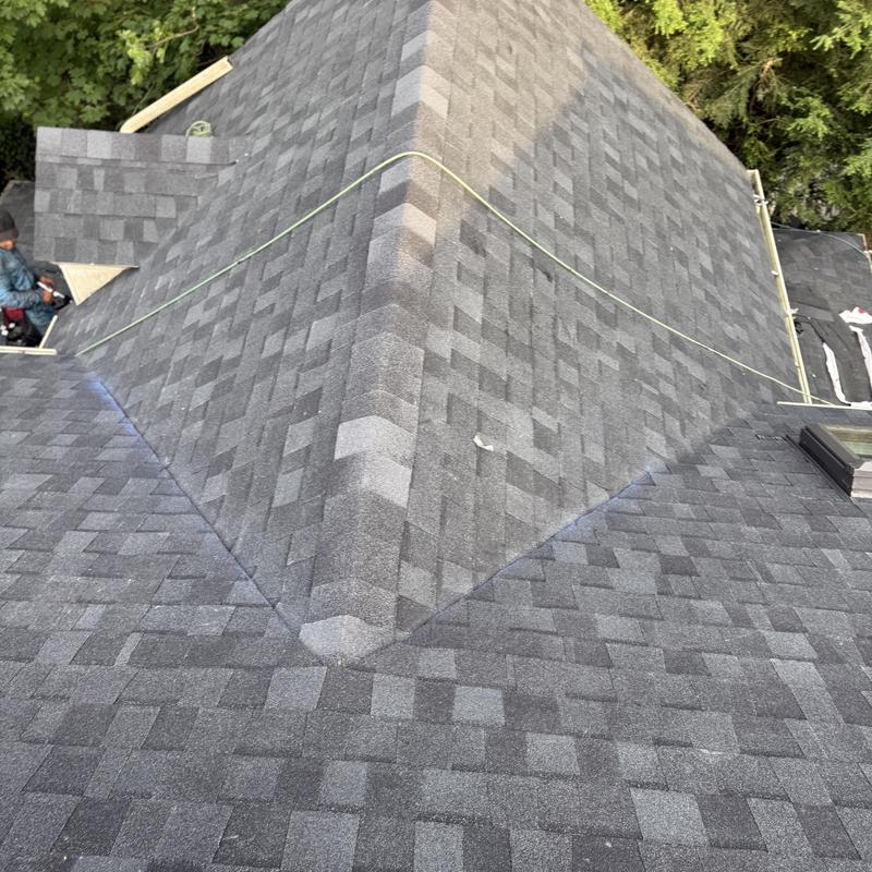 Asphalt shingle roof with ridge cap and vent installation
