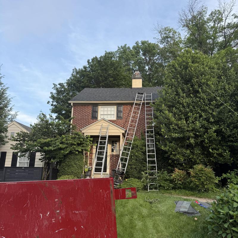 Wind-damaged roof with ladders for temporary repairs