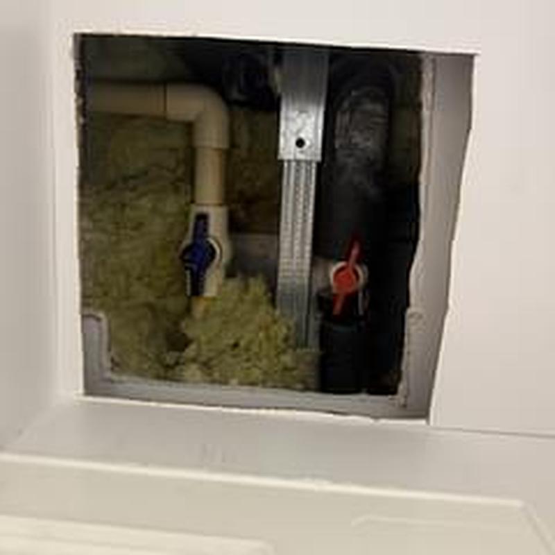 Shower valve access with red and blue handles Shower valve access with red and blue handles