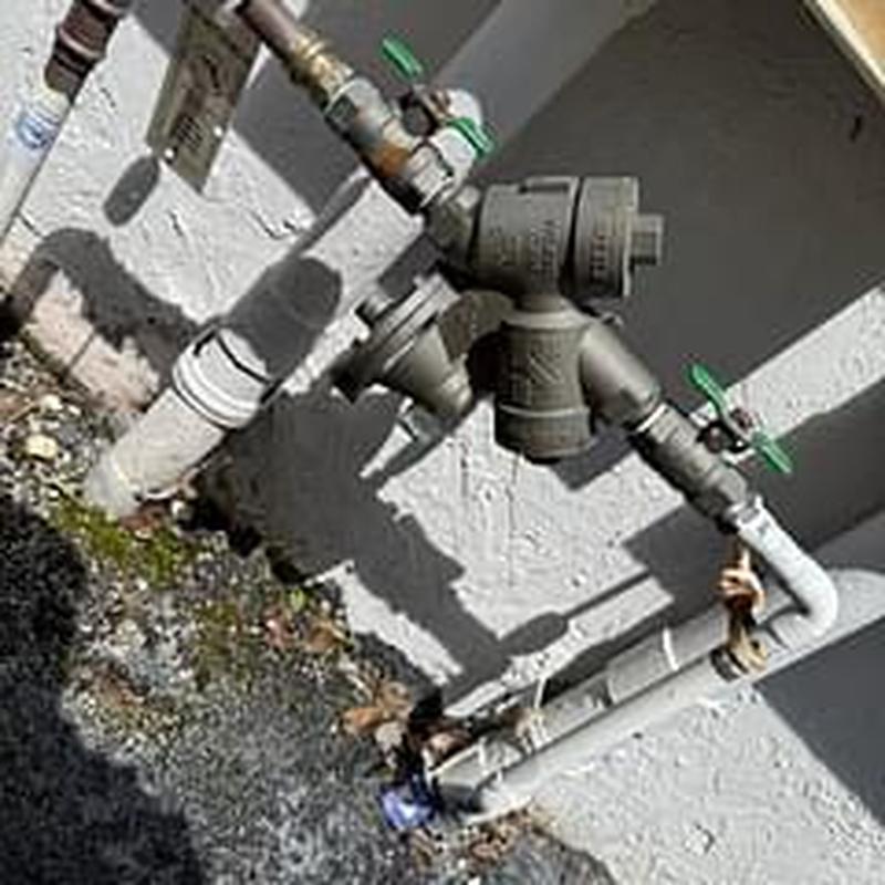 Backflow prevention device with outdoor piping and valves