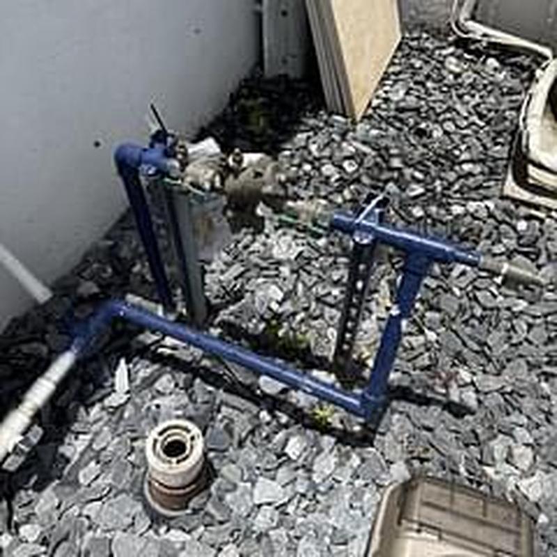 Backflow prevention device with water pipes outdoors