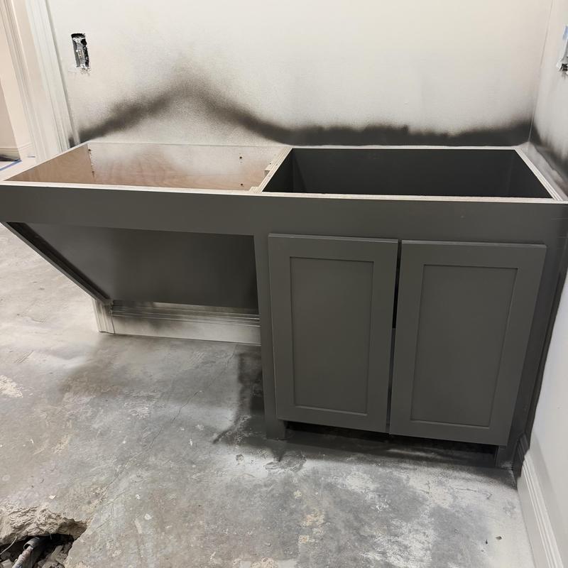 Gray cabinet base with fresh paint and open countertop slots