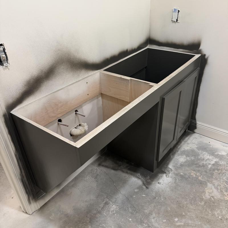 Bathroom vanity cabinet installation with fresh paint