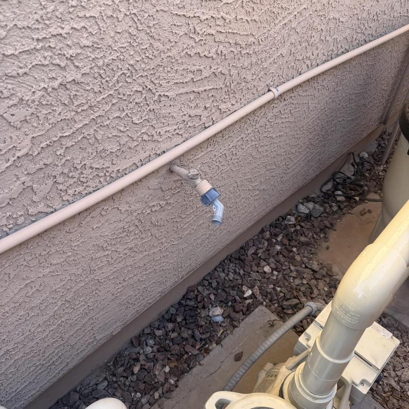 Outdoor hose bib with attached water timer on wall