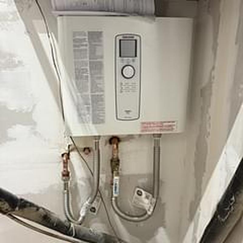 Tankless electric water heater installed with piping Tankless electric water heater installed with piping