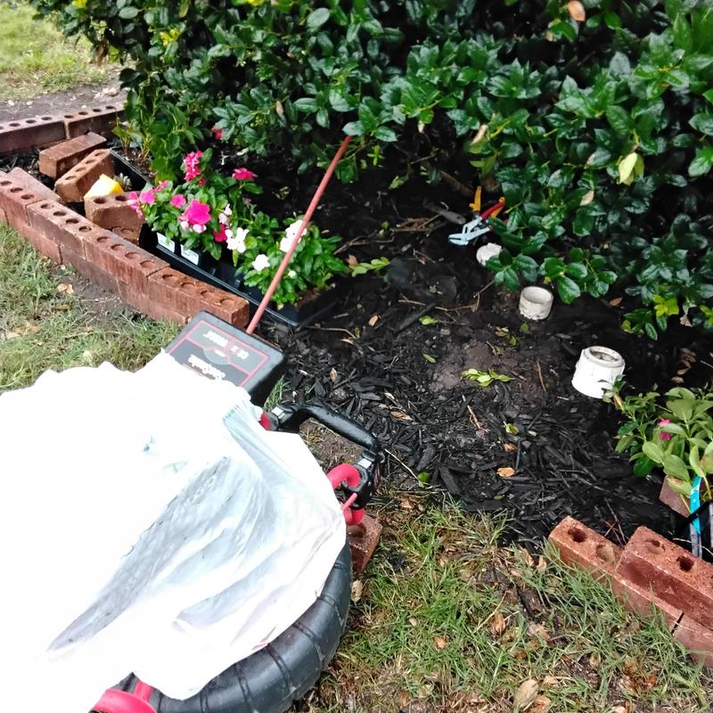 Drain pipe with cable and inspection camera in garden bed