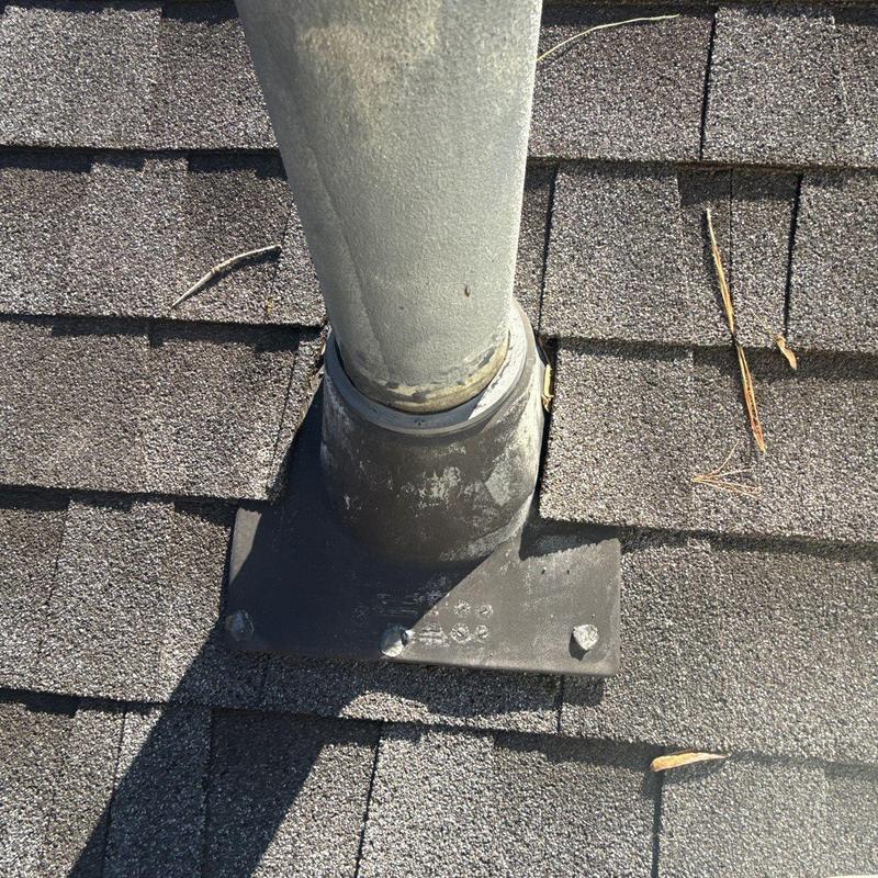 Roof pipe flashing with hail damage on shingles