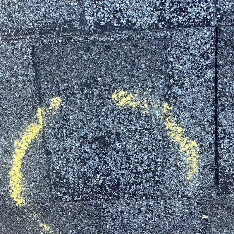 Asphalt shingle hail impact marked for repair