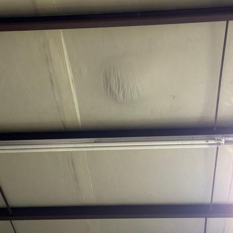 Commercial roofing membrane showing hail damage dents
