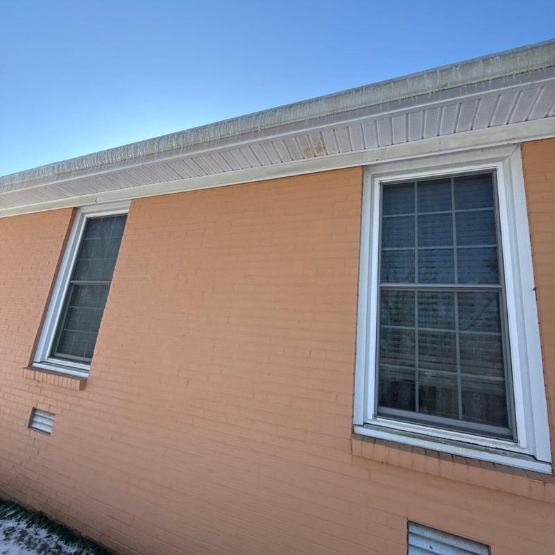Gutter and fascia inspection on brick exterior wall