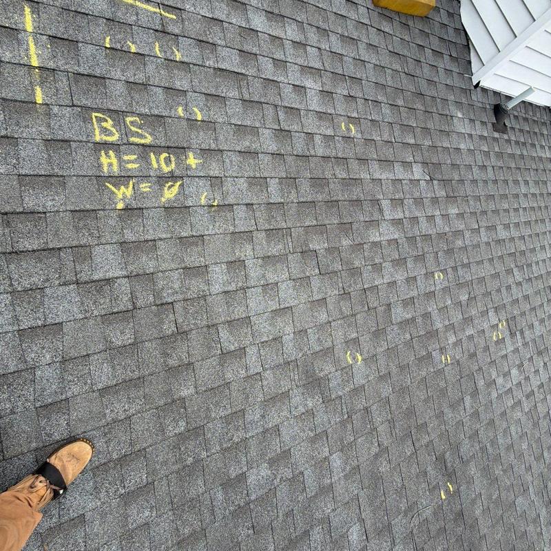 Asphalt shingle roofing with hail damage markings