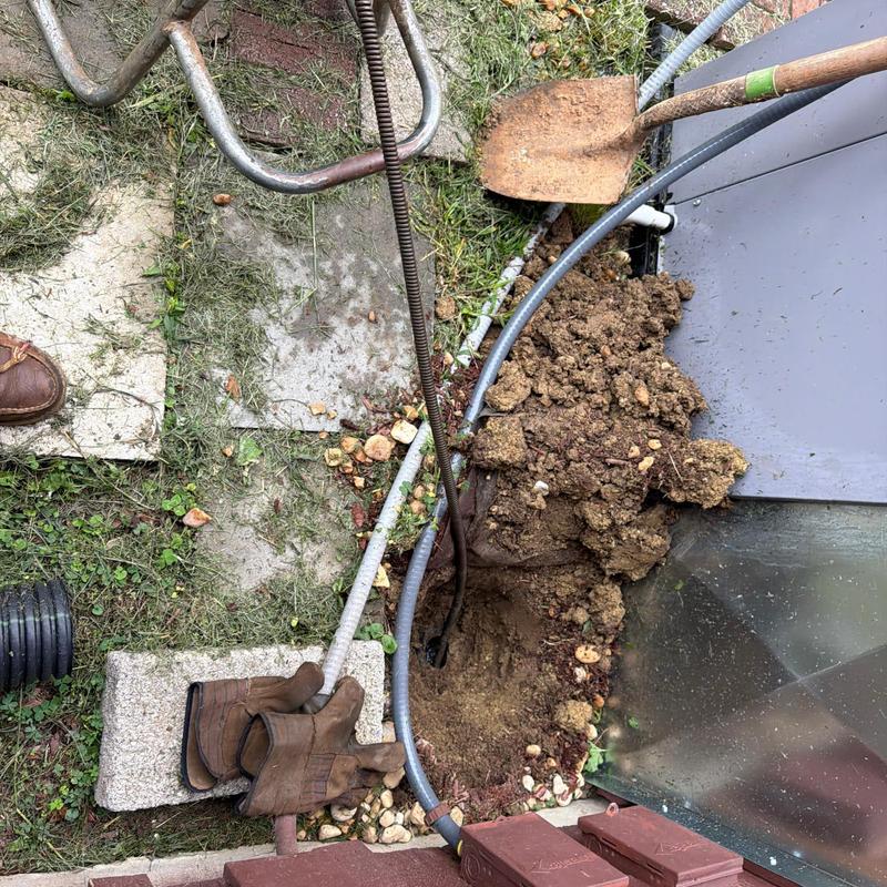 Mainline cable with plumbing tools and soil excavation