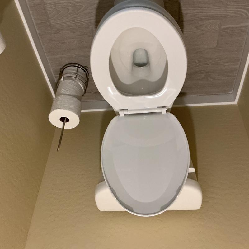 Toilet bowl with seat and roll holder installation