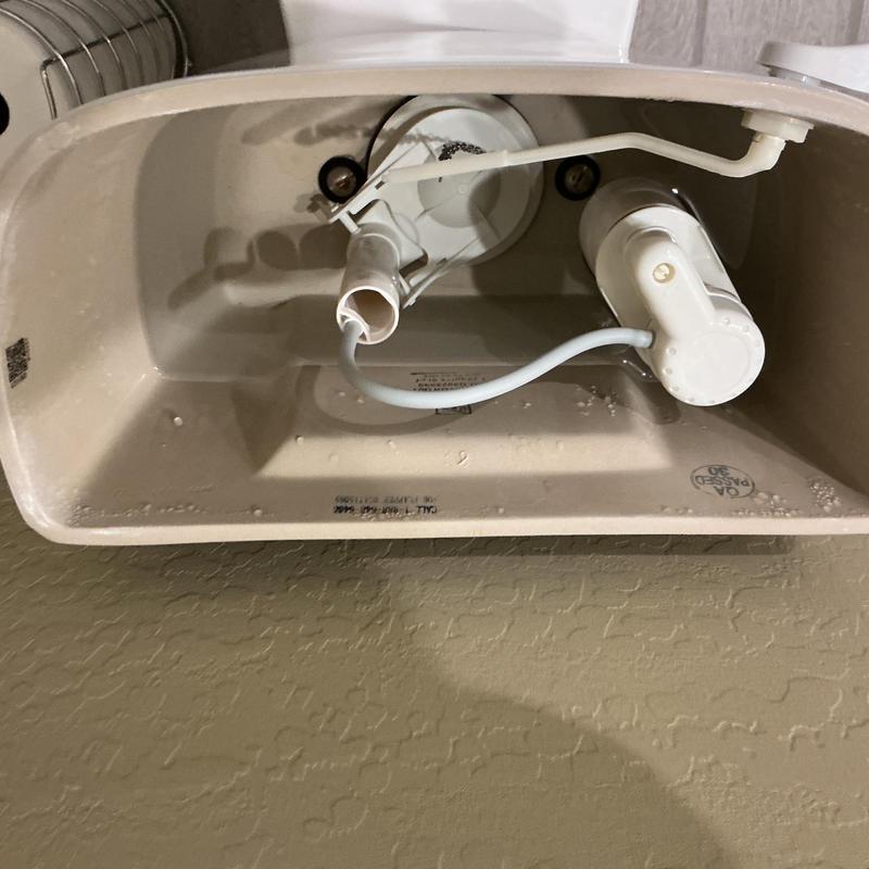 Toilet fill valve inside tank with components