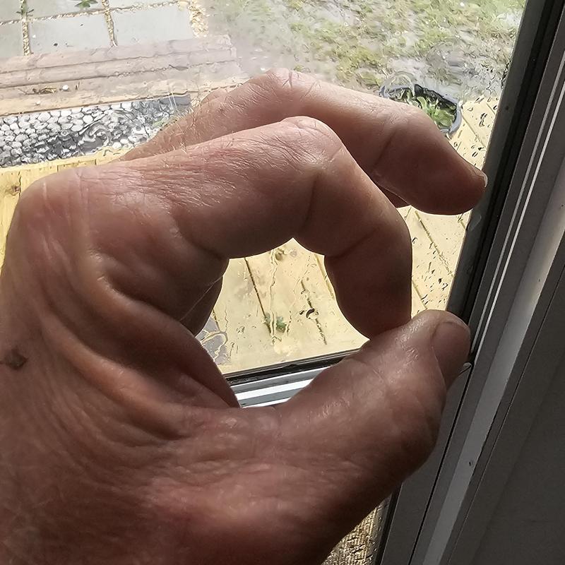 Window glass with hail damage close-up inspection