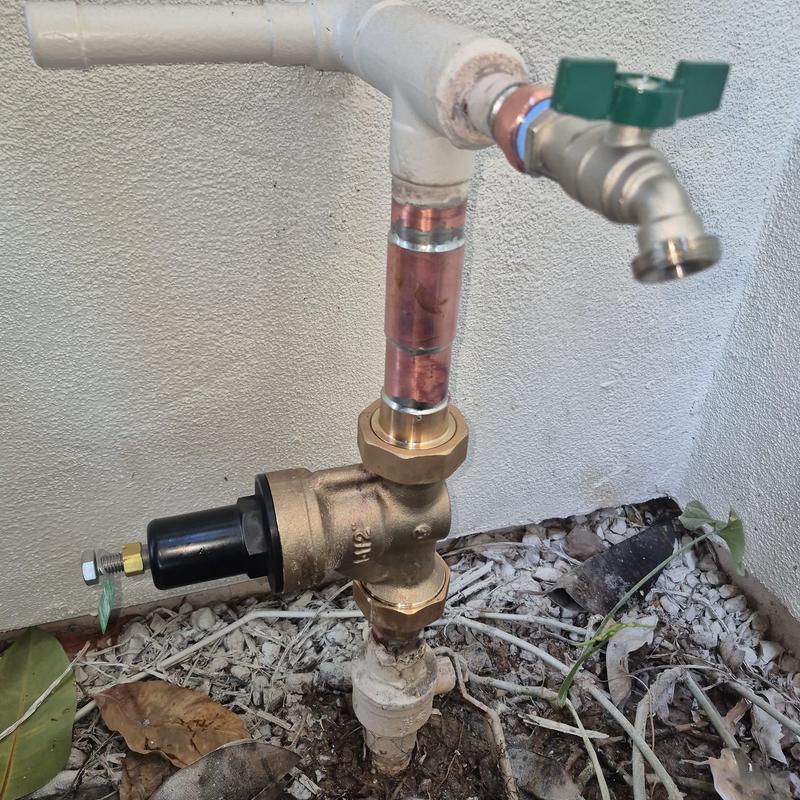 Pressure regulator valve with outdoor hose bib