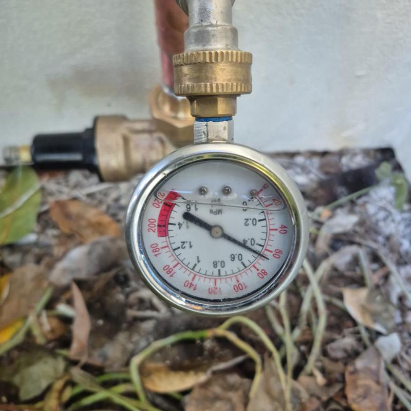 Pressure regulator valve gauge on outdoor hose bib