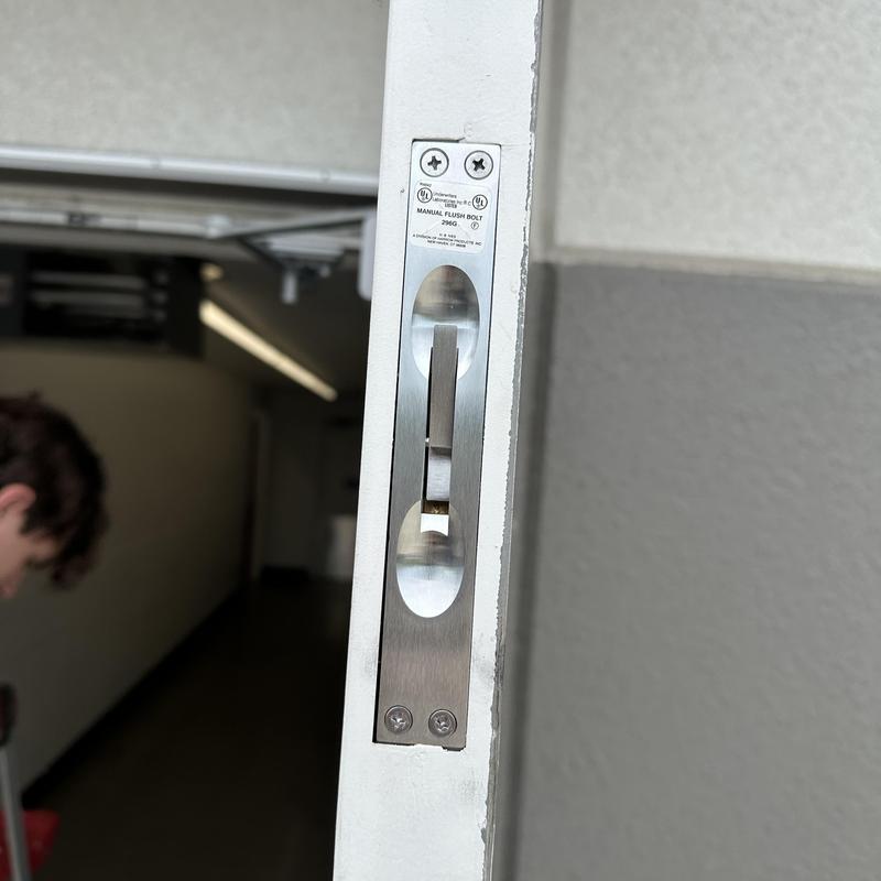 Flush bolt lock on commercial metal door edge
