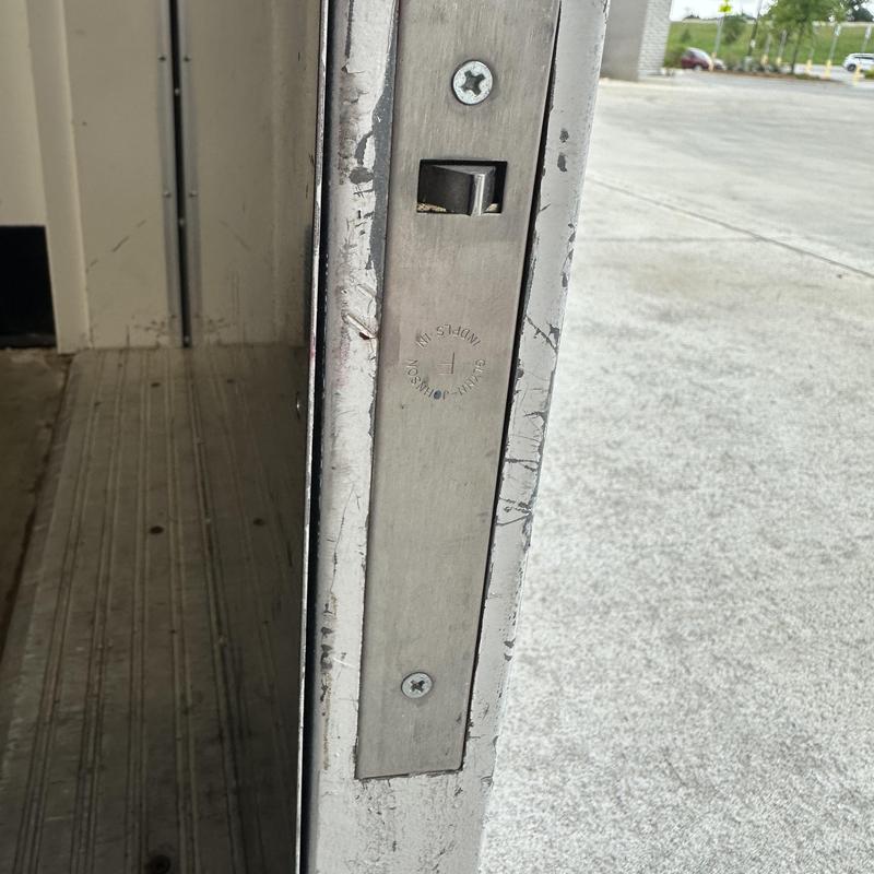 Flush bolt on commercial metal back door, shopping center