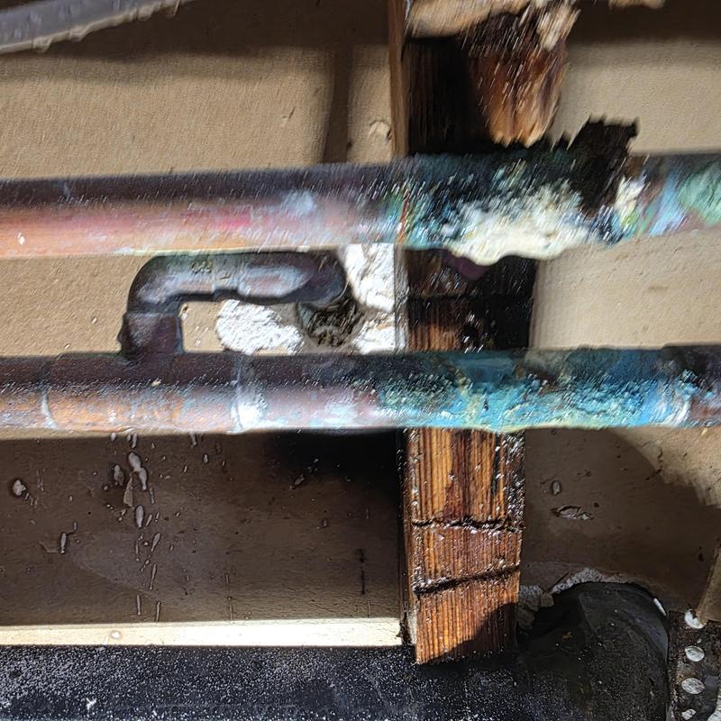 Hot copper water line with corrosion and leak damage Hot copper water line with corrosion and leak damage