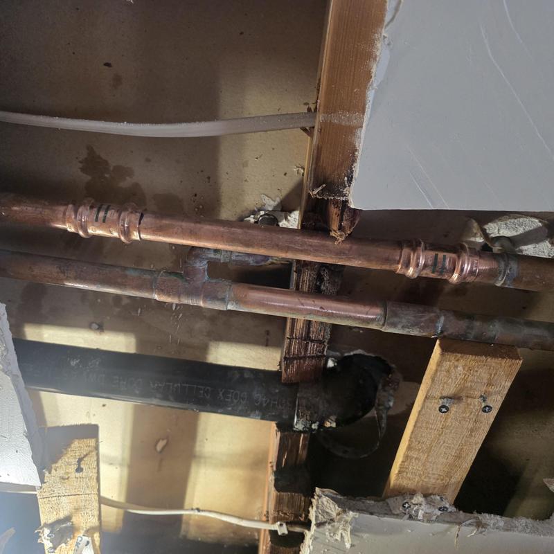 Copper hot water line with new pipe section installed Copper hot water line with new pipe section installed