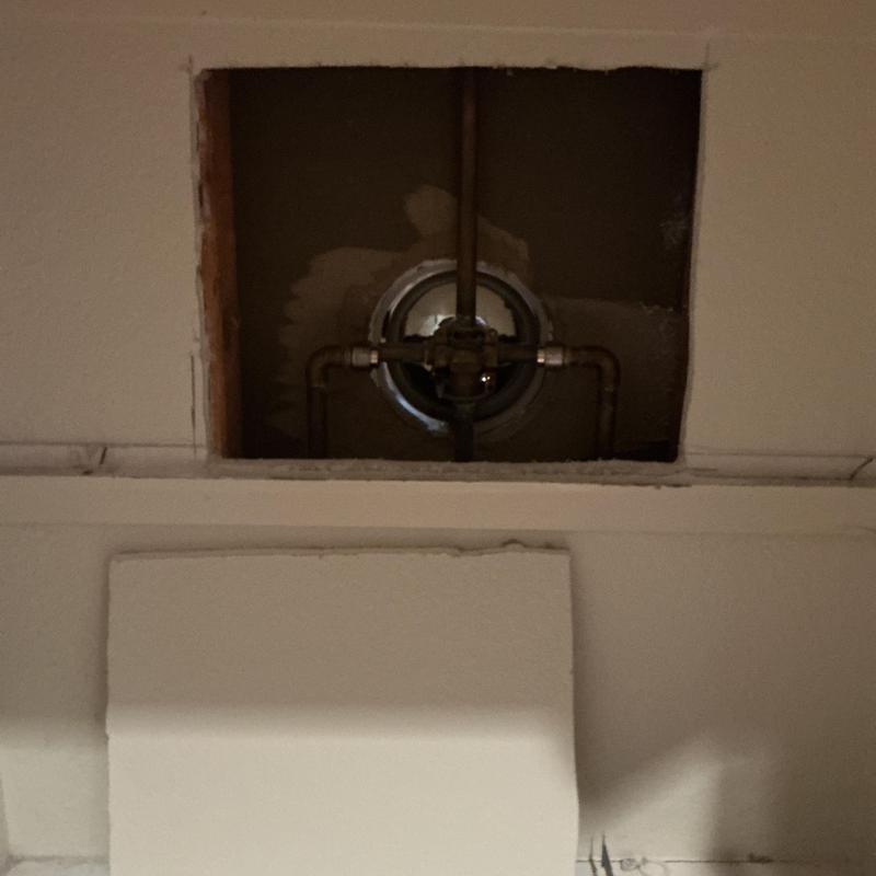 Tub shower valve with exposed plumbing in drywall hole